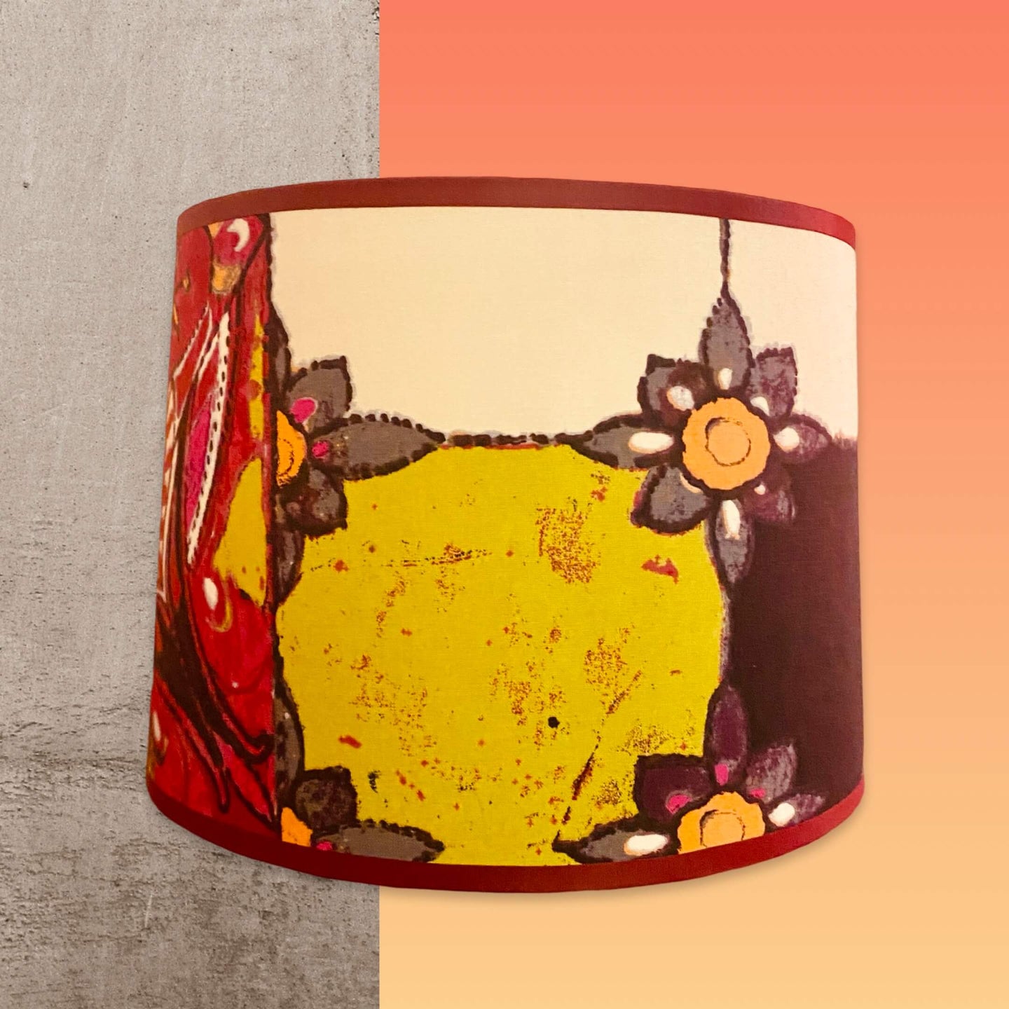 Abat jour de forme tambour revêtu d'un coton contrecollé. Motifs vitraux prune, rose, vert, écru.